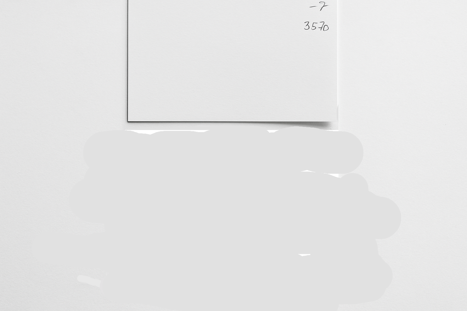 A mostly blank white sheet of paper with handwritten notes and numbers running off the right edge, showing planning thoughts spilling out before structure is set.